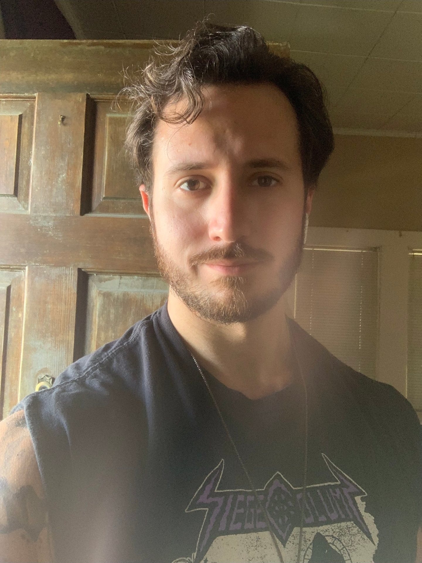 Coach Garret, close up, in a band T-shirt