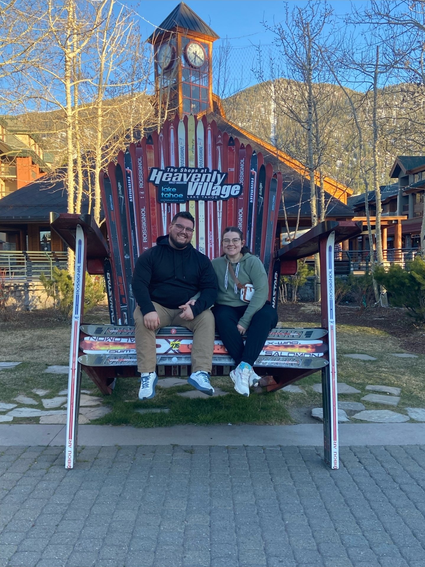 Jessie and Emily sitting together in the giant ski chair at Heavenly Village, Lake Tahoe
