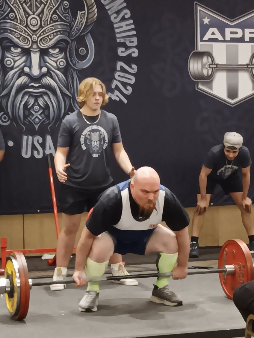 A Train Unique lifter pulling a deadlift on the platform