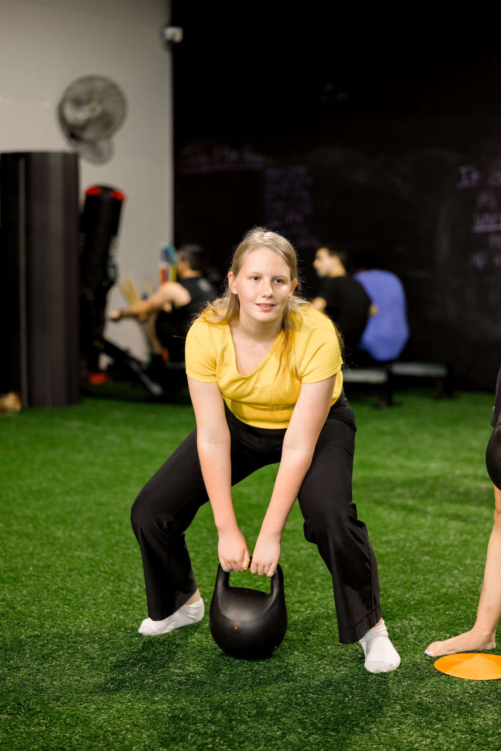 An athlete lifting a kettlebell