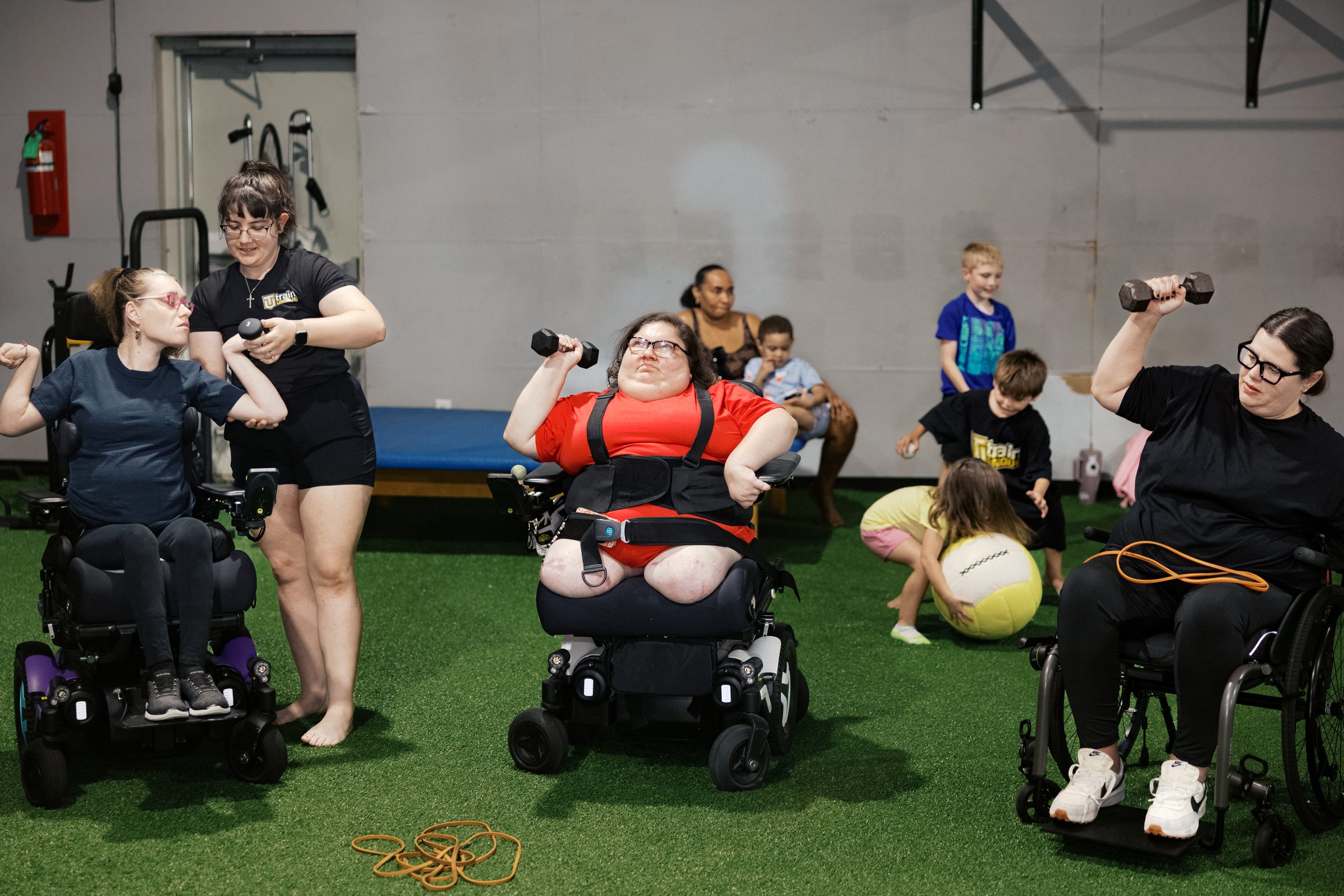 A class of athletes training with dumbbells from their wheelchairs