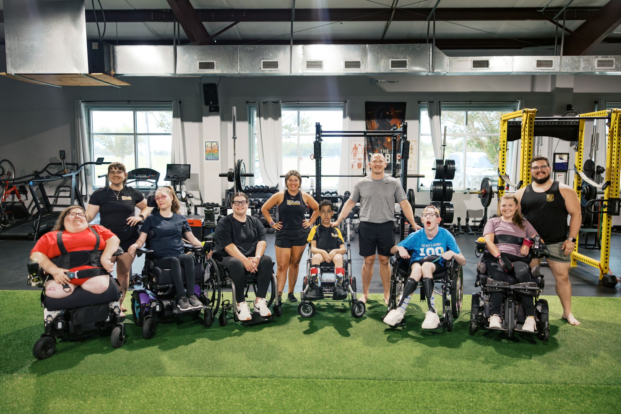 Athletes in their chairs and their coaches together on the floor