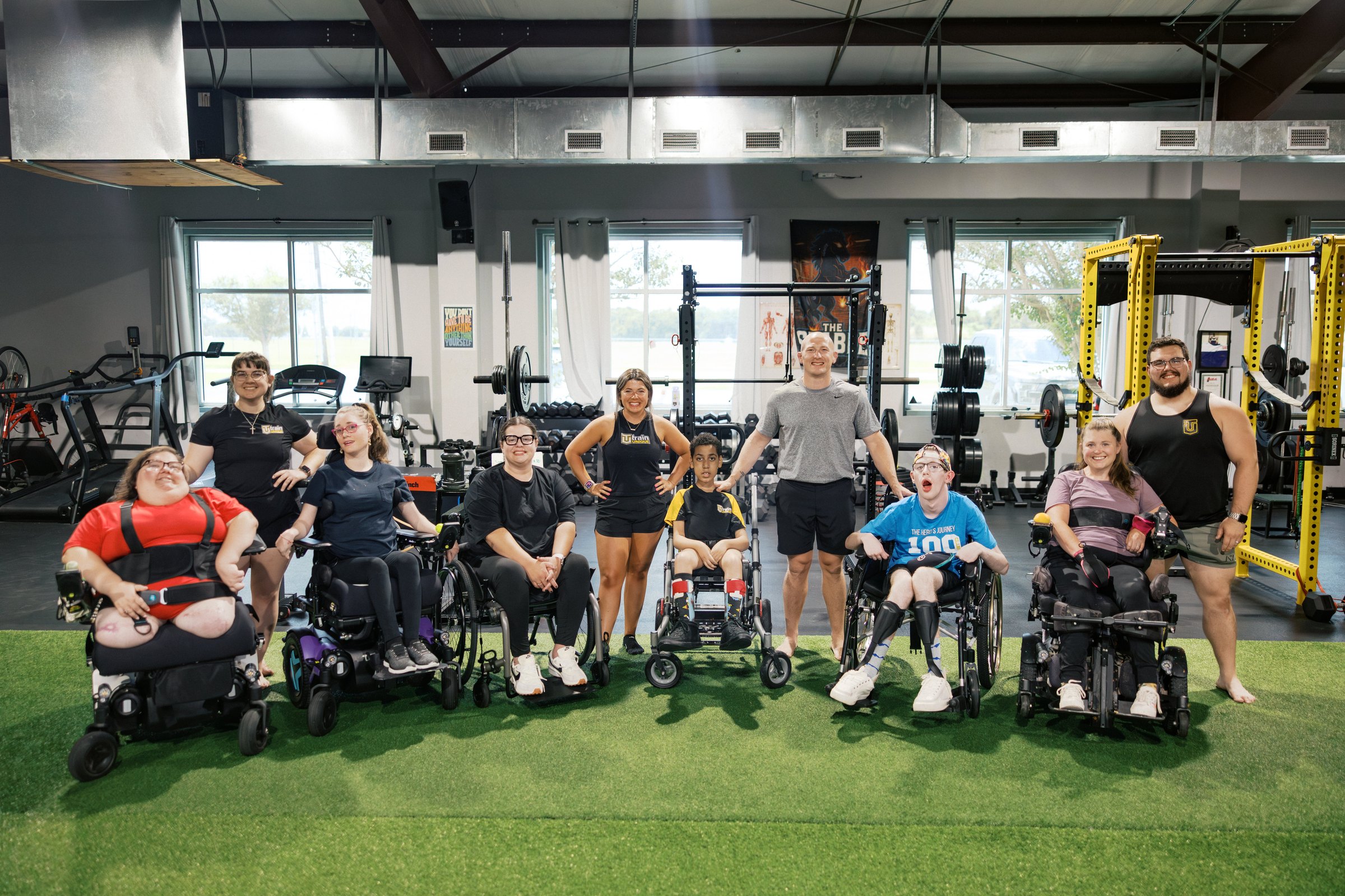 Athletes, wheelchairs and coaches together on the gym floor